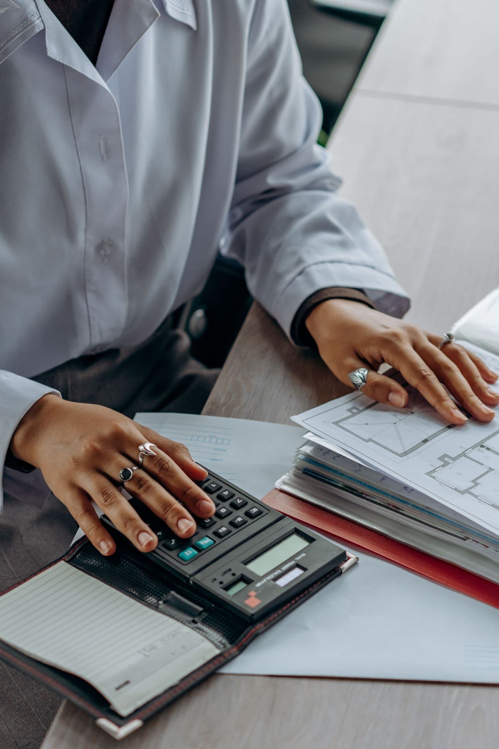A healthcare billing specialist reviewing claim paperwork at a desk