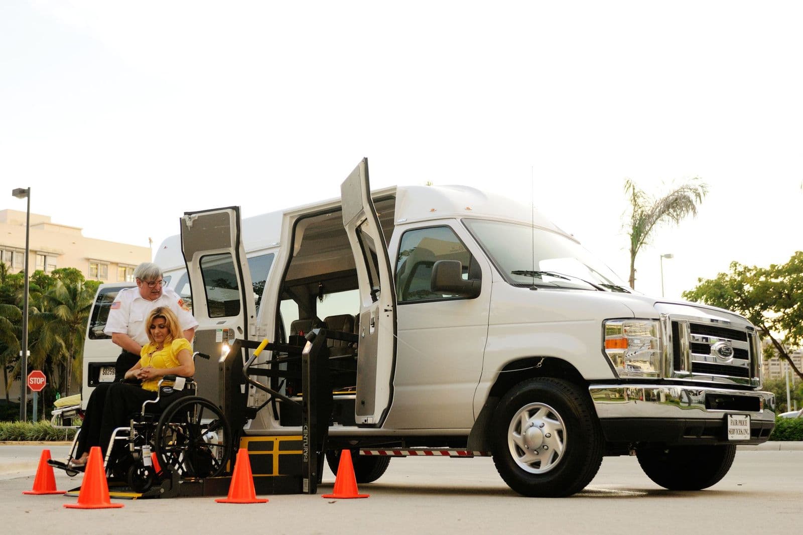 A passenger in a wheelchair boarding an accessible van on its powered lift
