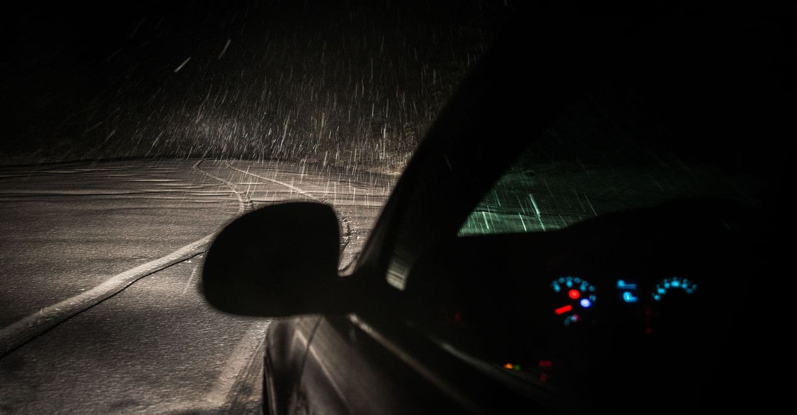 The view through a vehicle windscreen while driving at night